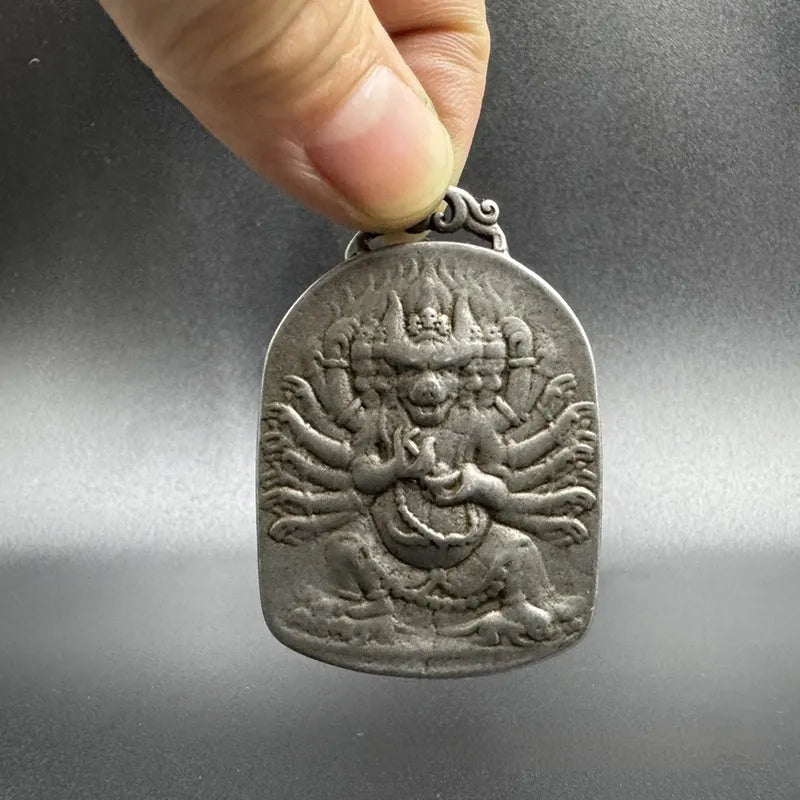 Close-up of an antique iron pendant with Chinese geometric patterns, design Aryaacalanatha Yamantaka.