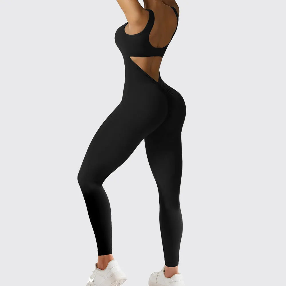 Woman wearing a sleeveless army green flare-leg jumpsuit for yoga fitness.