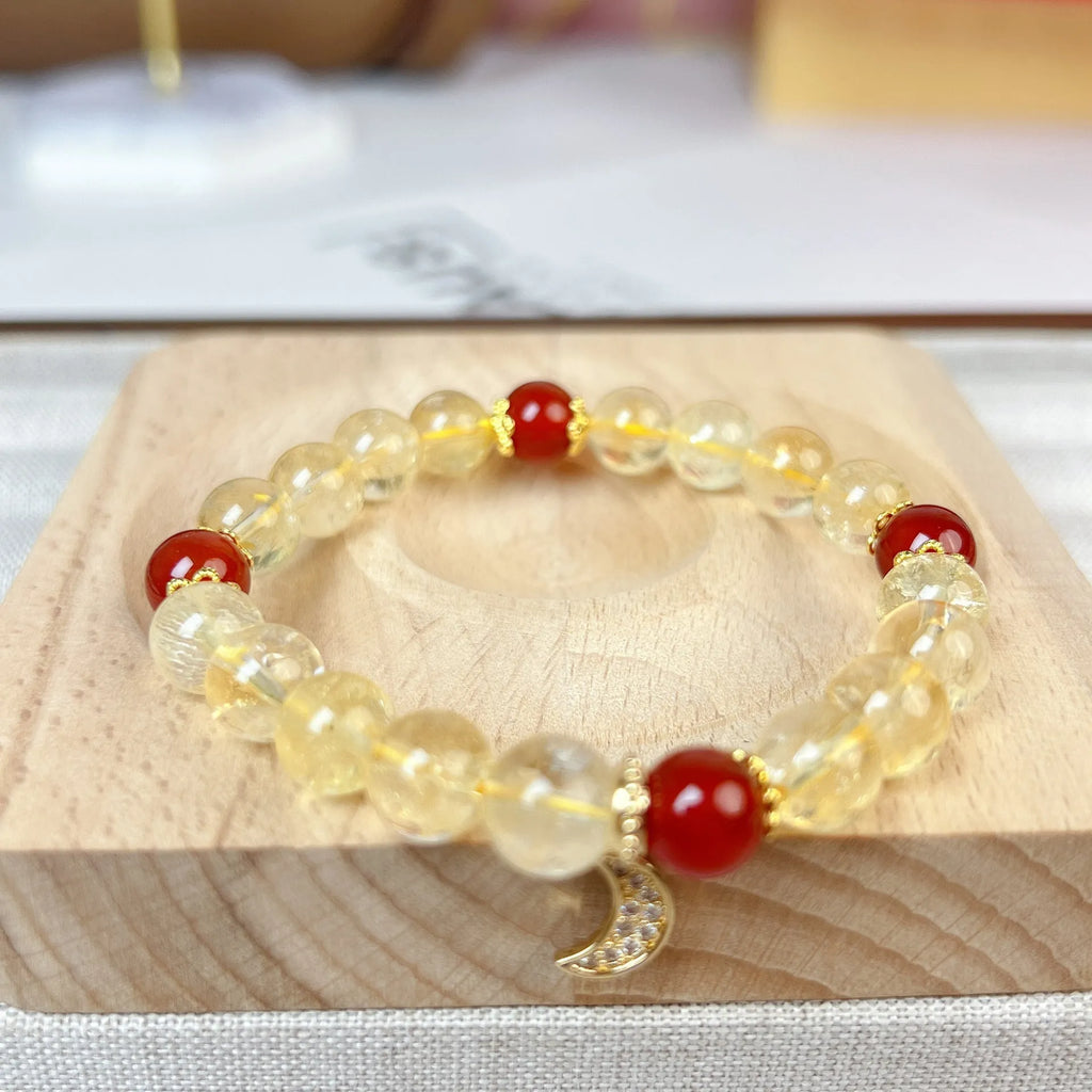 Women's handmade crystal bracelet featuring citrine and red agate beads in a moon boom style.