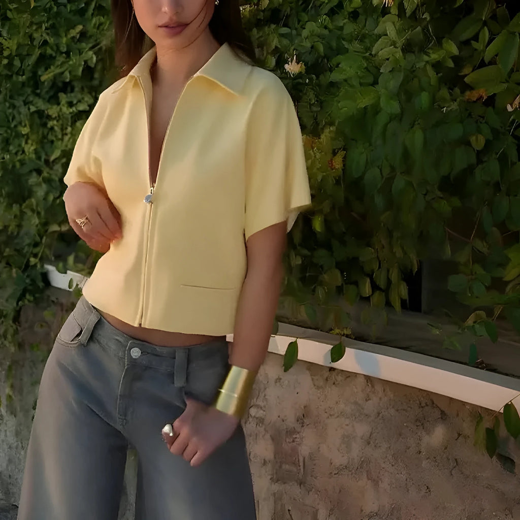 A woman wearing a loose-fit yellow short sleeve casual polyester top.