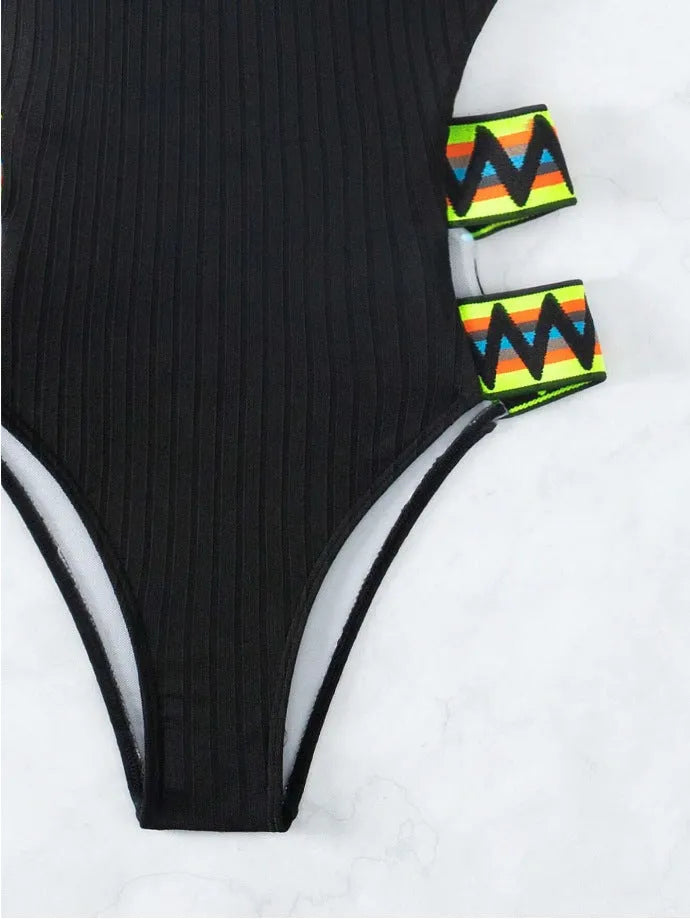 Black and orange solid colour women's one-piece polyester swimsuit on size chart.