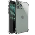 Clear transparent TPU shockproof phone case for various iPhone models on a table.