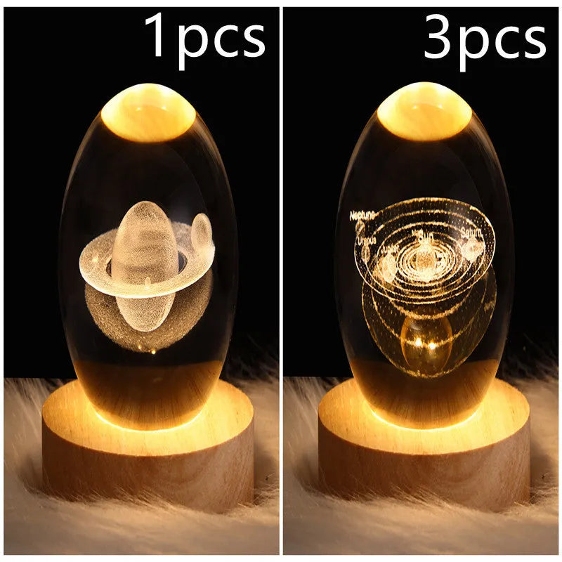 LED galaxy crystal ball night light with 3D planet designs on a table