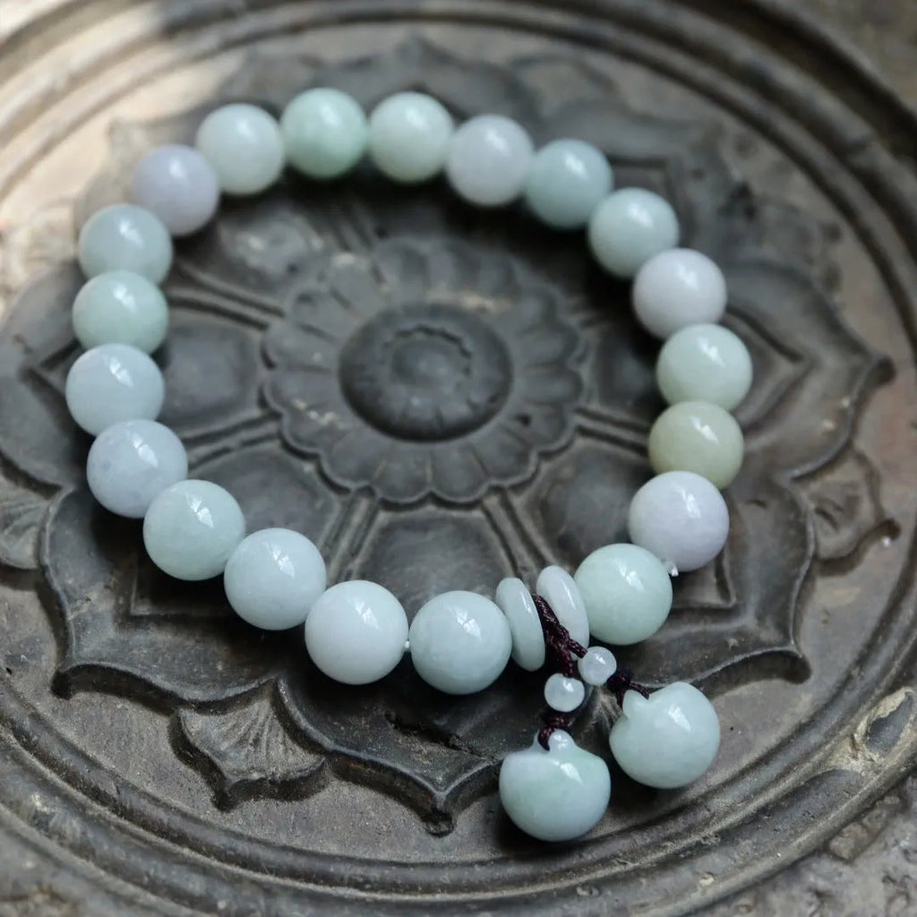 Emerald green jade hanging bracelet with Maitreya Buddha charm and geometric shapes