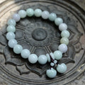Emerald green jade hanging bracelet with Maitreya Buddha charm and geometric shapes