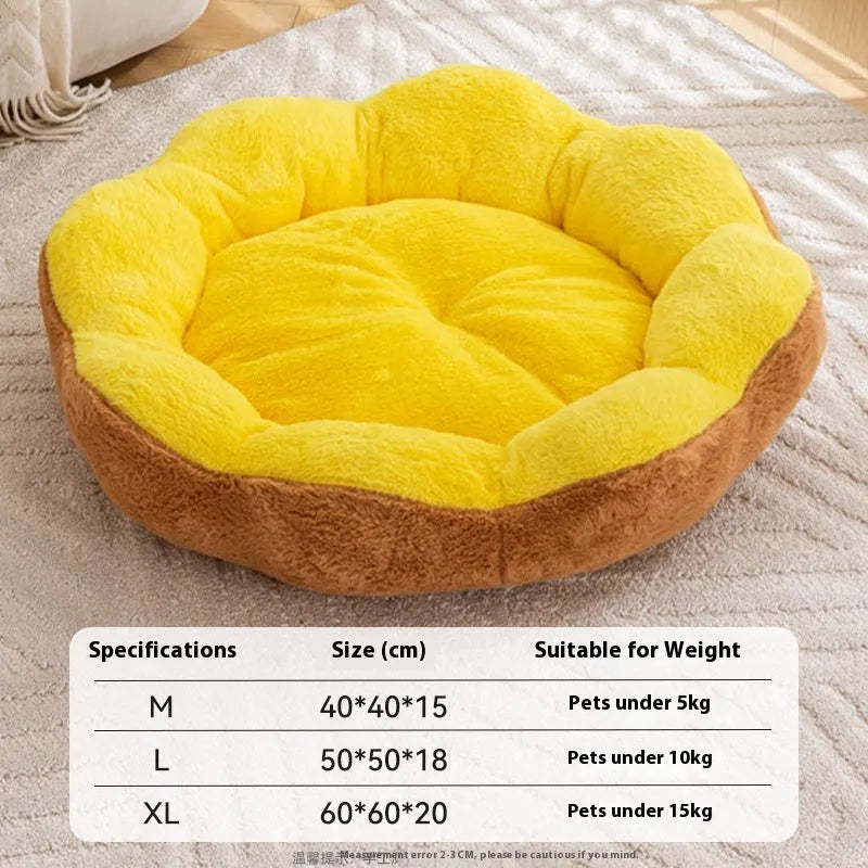 A thick grey and black plush round cat bed nest with raised sides on a wooden floor.