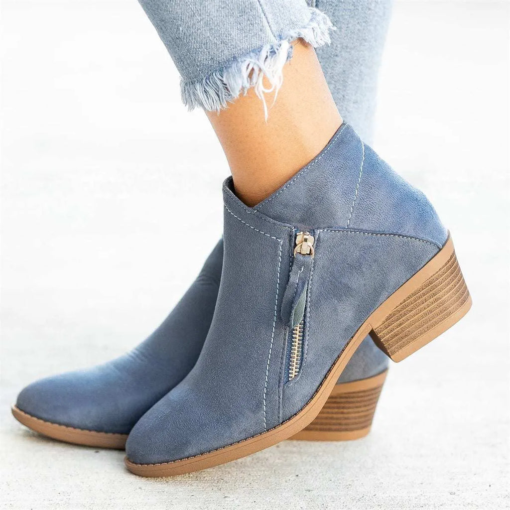 Women's beige suede ankle boot with side zip, lace-up front, and chunky composite sole.