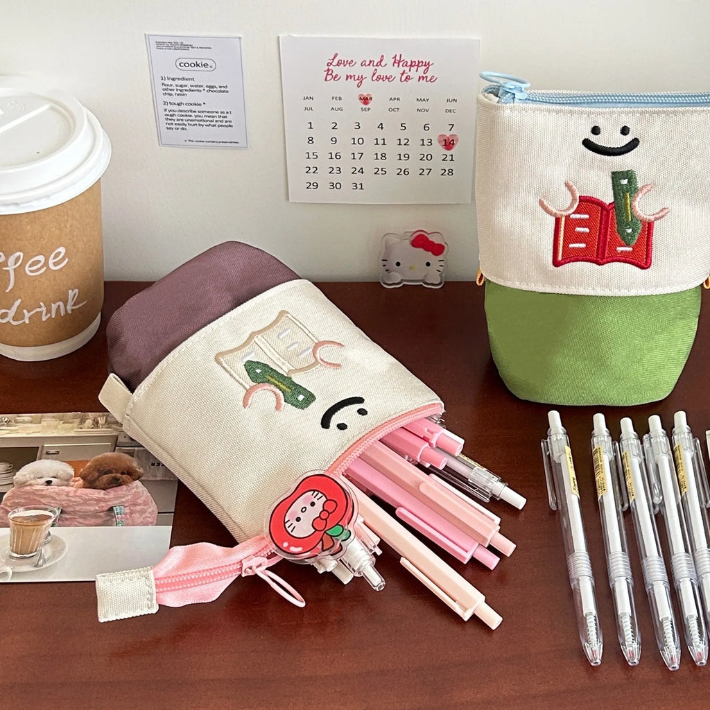 Brown and green Korean-style collapsible Oxford fabric pencil case showing 17cm by 14cm size.