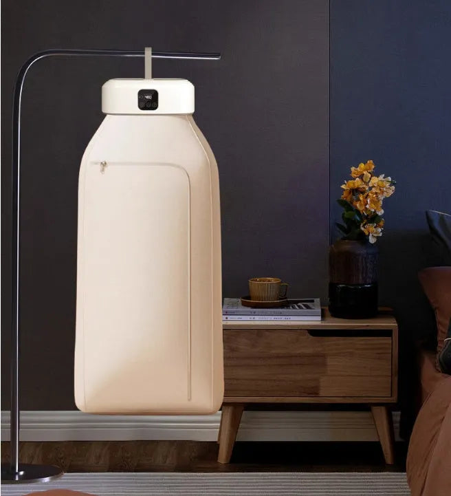White cylindrical compact clothes dryer with remote control for dormitory use