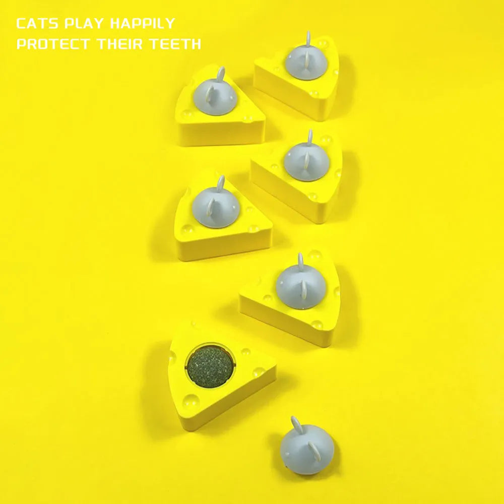 Yellow catnip and silvervine chew toy balls for cats on a plain background.