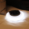 Blue and white Bluetooth speaker desk lamp with folded head on a wooden table, showing touch panel.