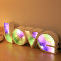 Rainbow halo style LED LOVE decorative light measuring 35.5cm wide