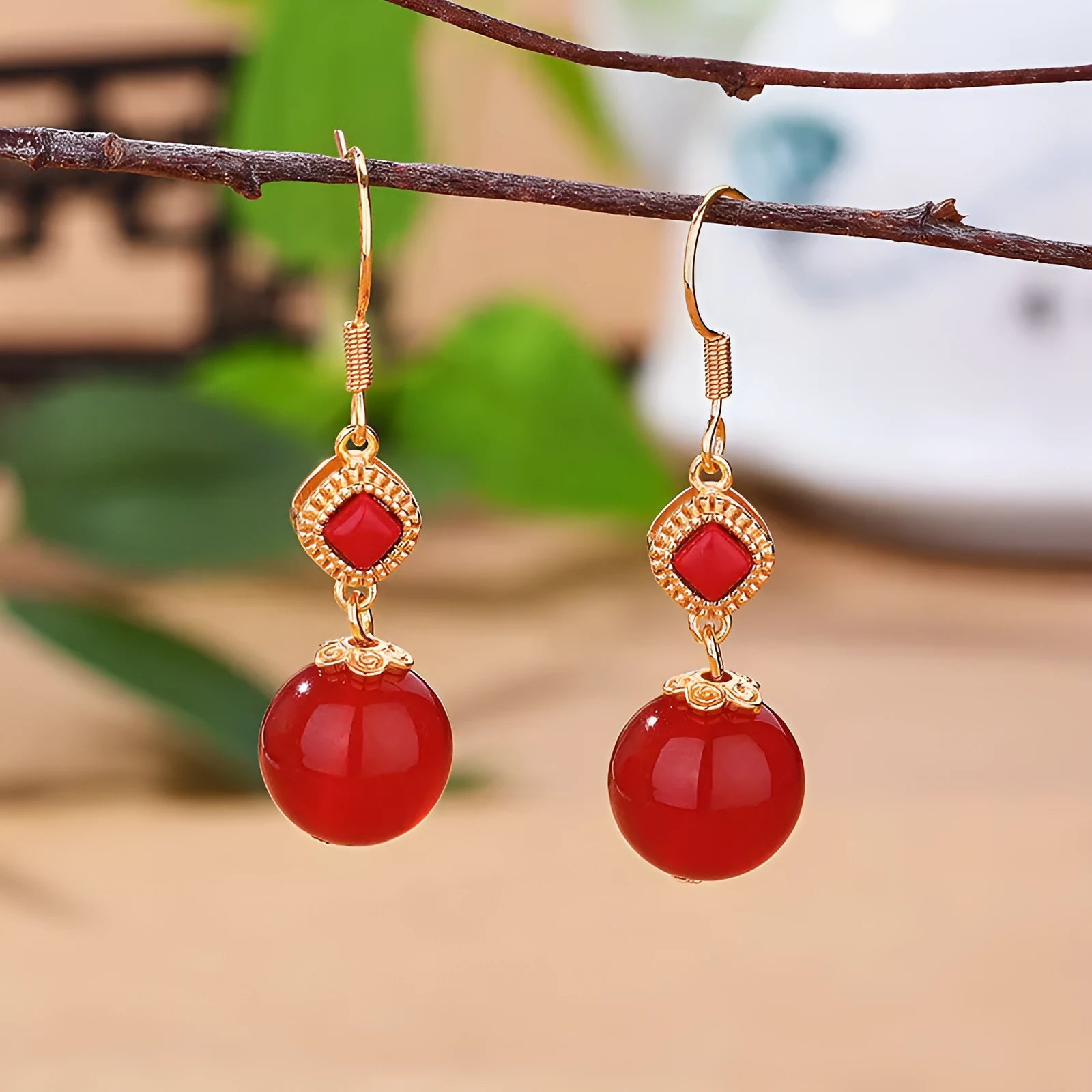 Geometric drop earrings with round Southern Red Agate beads and silver jasper inlay on an electroplated copper base.