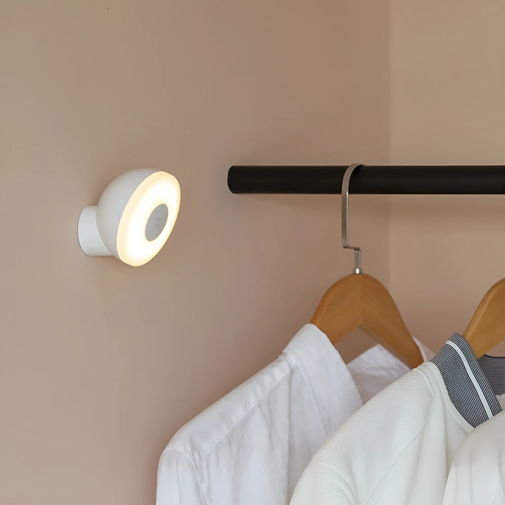 White Bluetooth induction bedside lamp with modern simple design on wooden nightstand