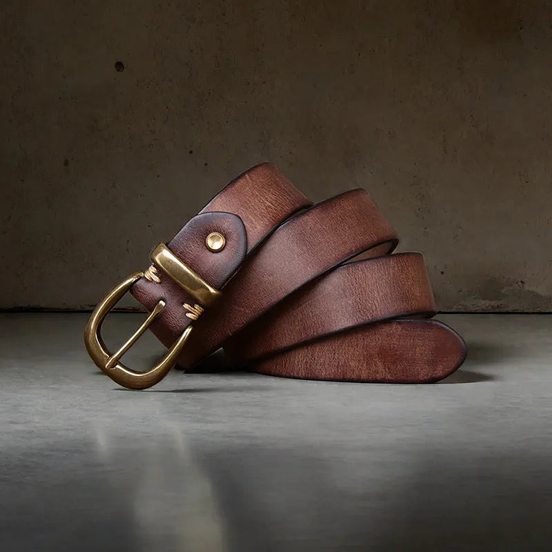 Men's brown casual leather belt with a copper pin buckle on a textured background.