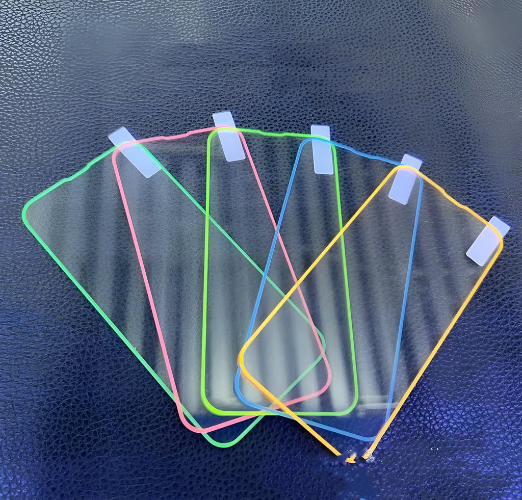 Fluorescent pink tempered glass screen protector glowing on an iPhone 13 Pro Max.