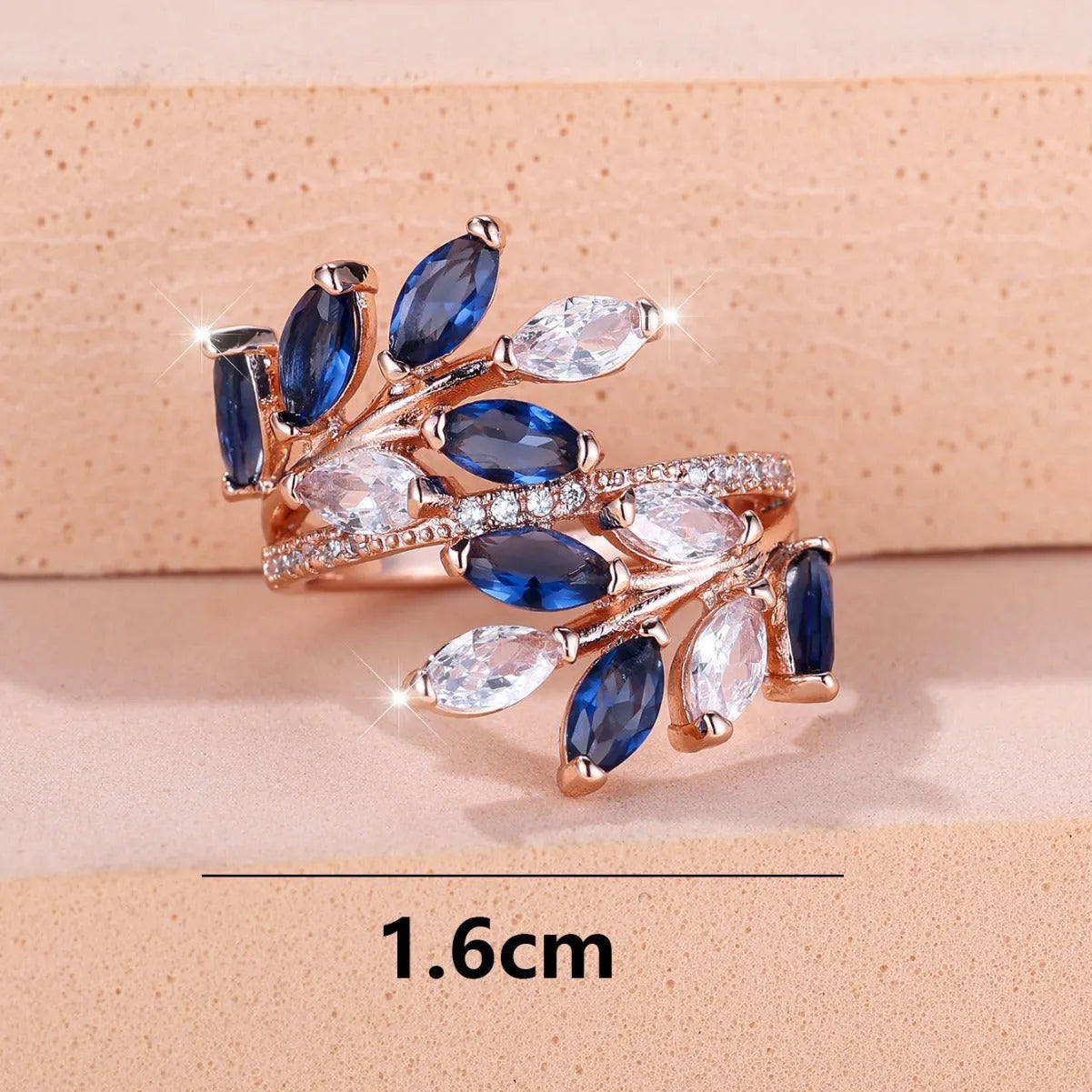 Close-up of an adjustable horse eye zircon leaf fashion ring in a rose gold finish with white stones.