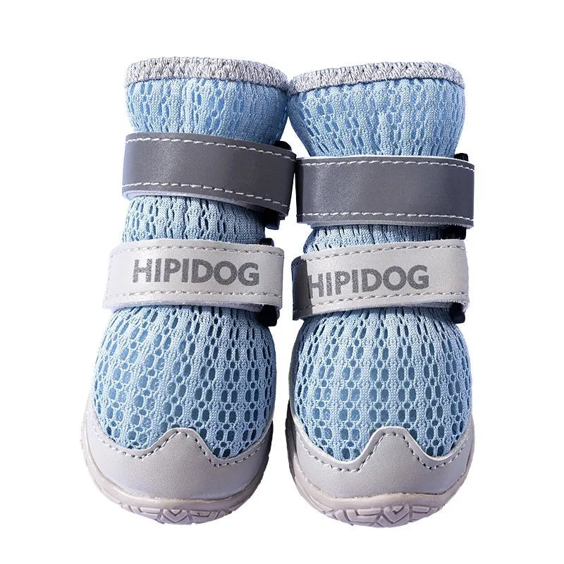 Cartoon style blue and green breathable dog shoes with adjustable strap on a pet's paw.