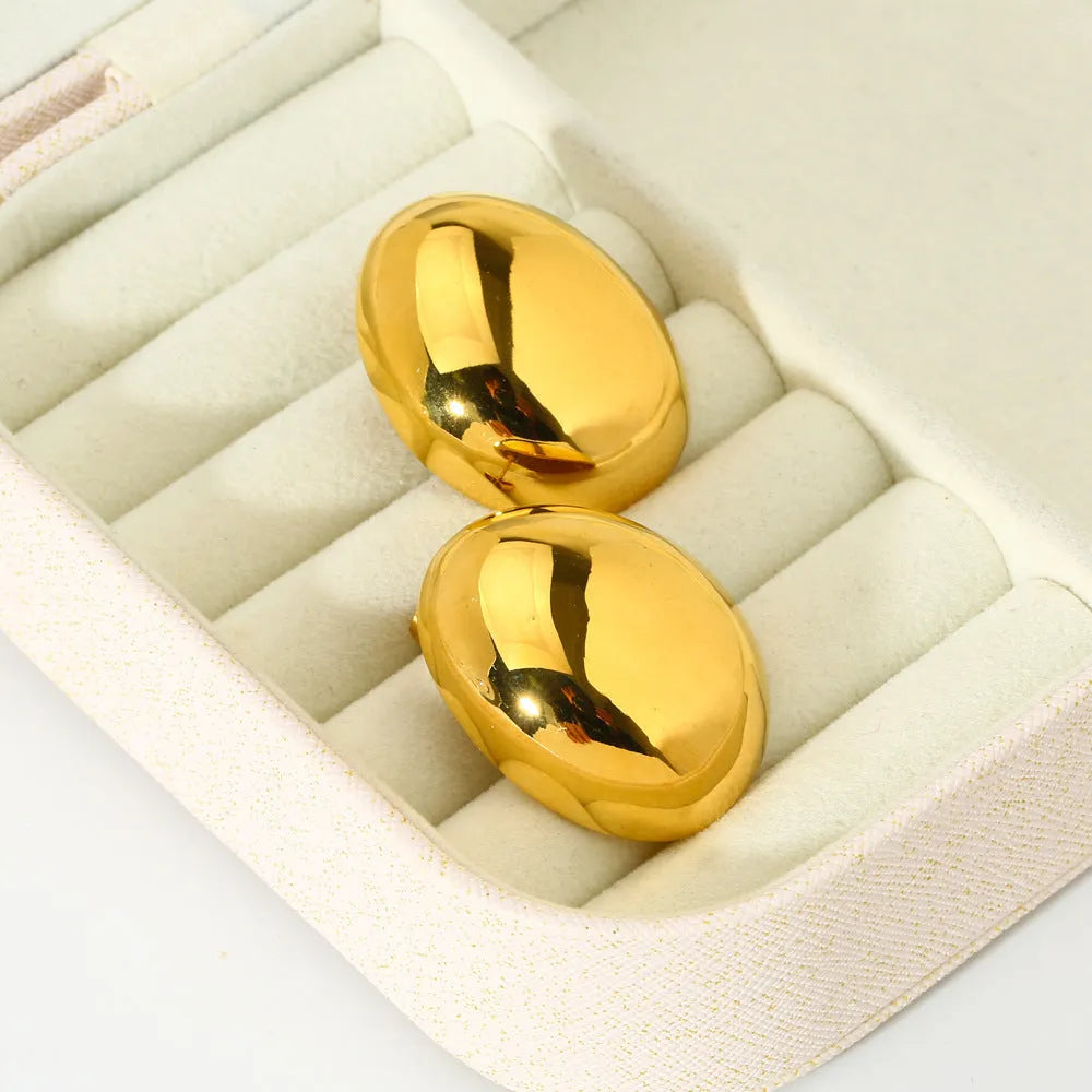Geometric stainless steel ear studs with a glazed, reflective surface in colour DFE139.