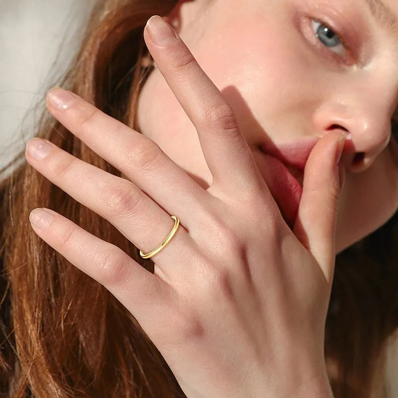 Simple geometric sterling silver bracelet ring on a wrist, shown in traditional and star design variants.