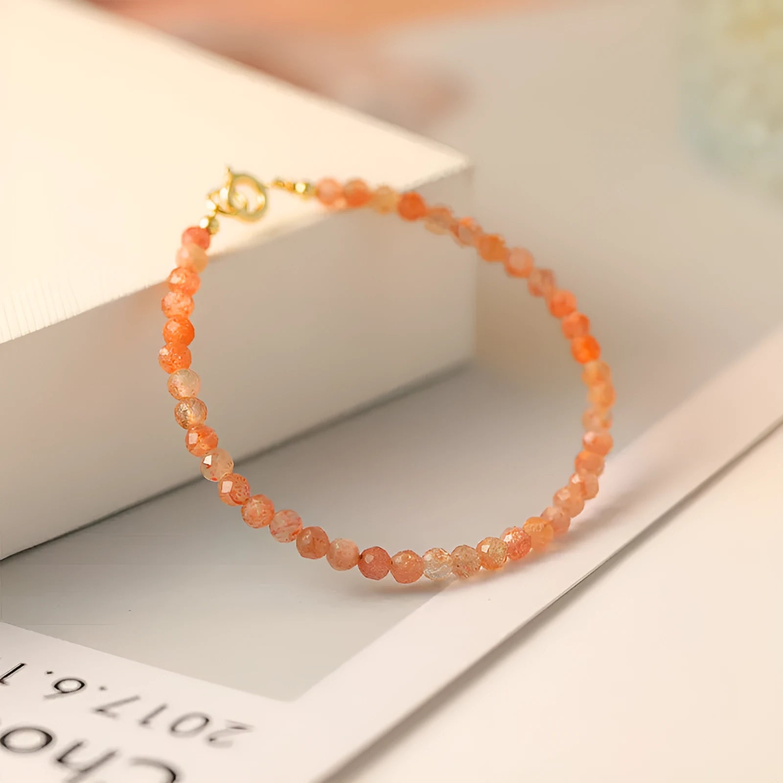 Sunstone crystal fortune bracelet with 3mm ultra-thin beads on female wrist
