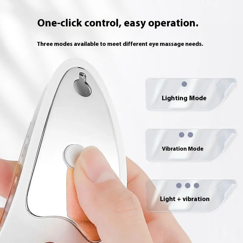 White portable rechargeable red light eye massager on a table