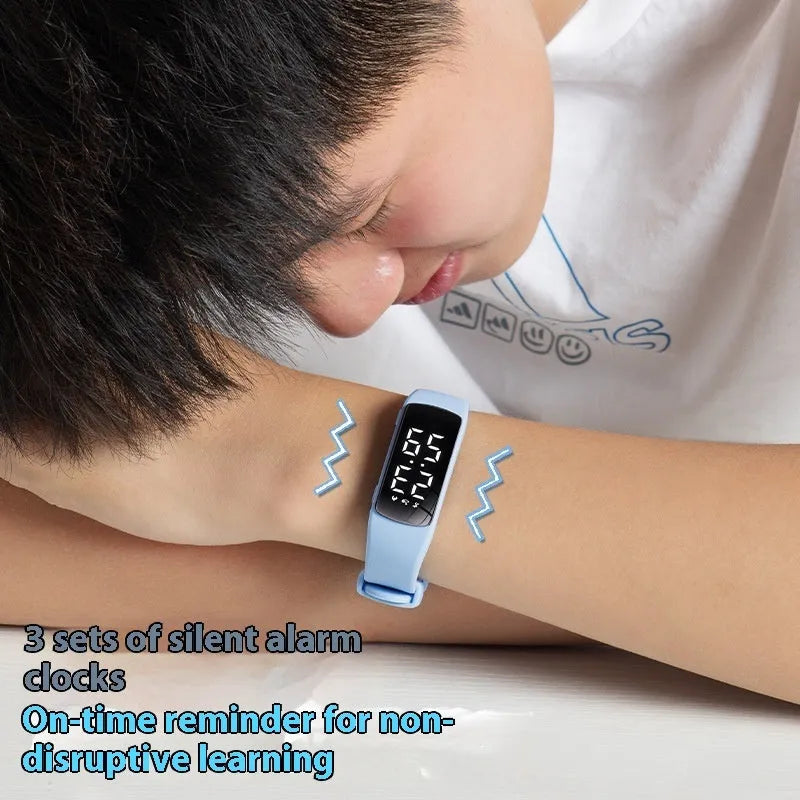 Vibration alarm smart watch with coloured silicone strap on a wrist, showing LED display.
