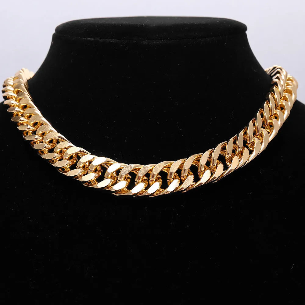 Women's gold tone thick chain necklace with a pendant on a white background.