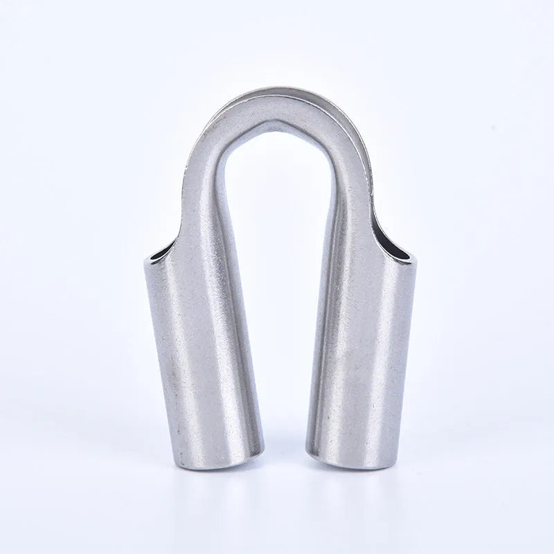 Stainless steel tubular chicken heart shaped sleeve ring set showing various metric sizes on a workbench.