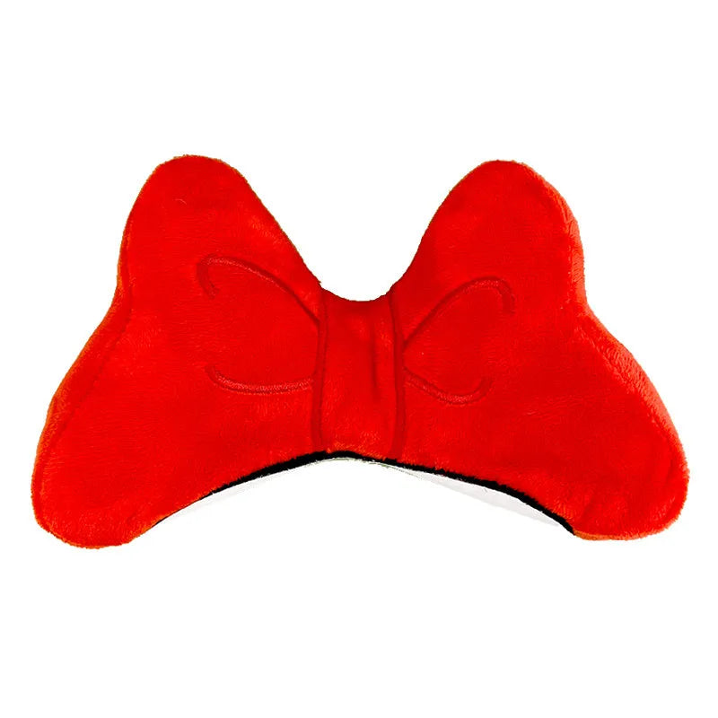 Soft plush decorative bow for clip-on attachment to a motorcycle or ski helmet.