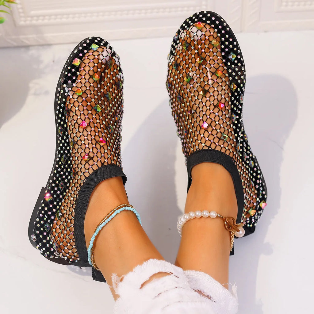Women's flat sandals with colourful rhinestones on a breathable mesh upper and rubber sole.