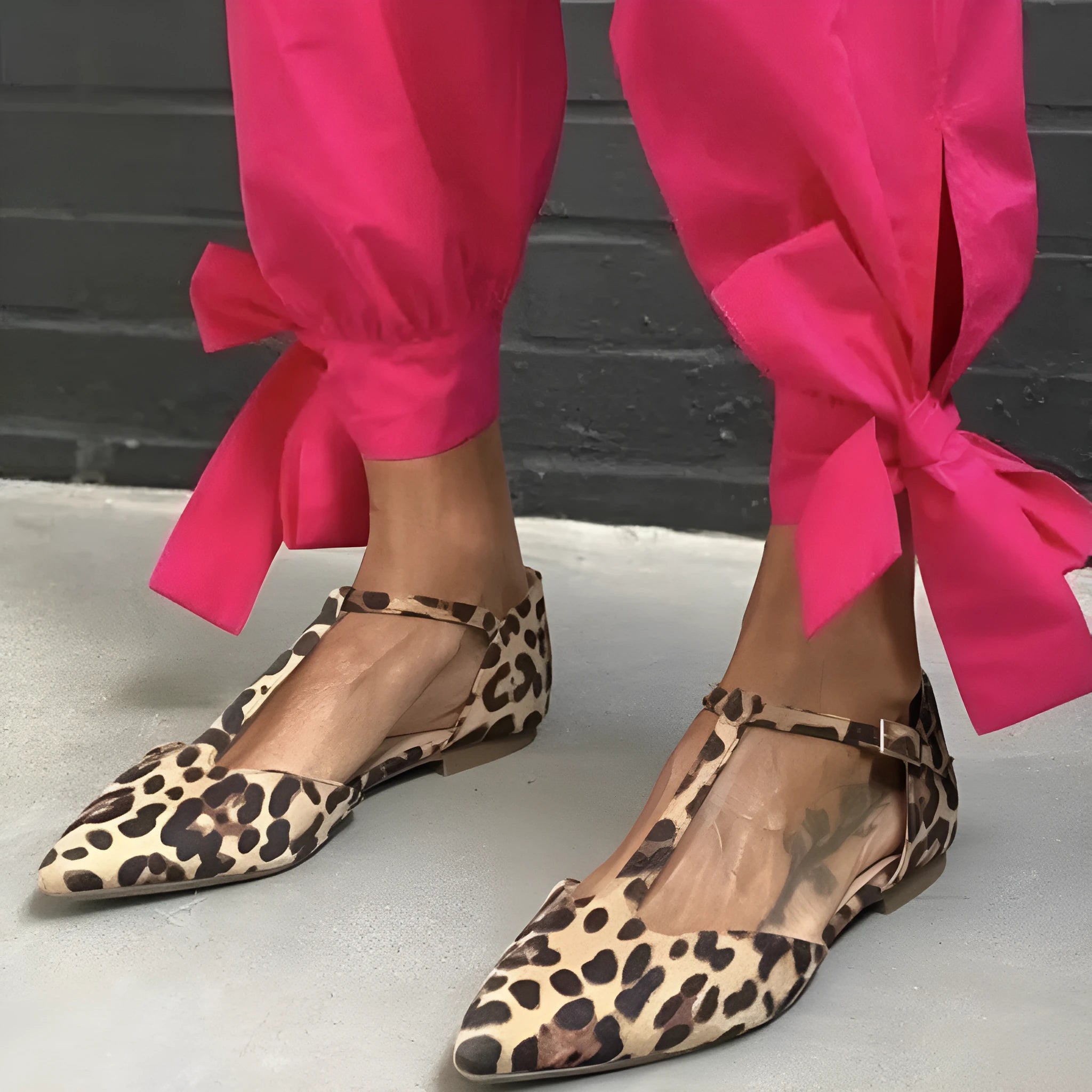 Women's black leopard print pointed toe pumps with a chunky low block heel and cross ankle straps.