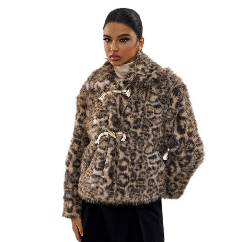 Women's leopard print coat with a buckle lapel fastener on a hanger.