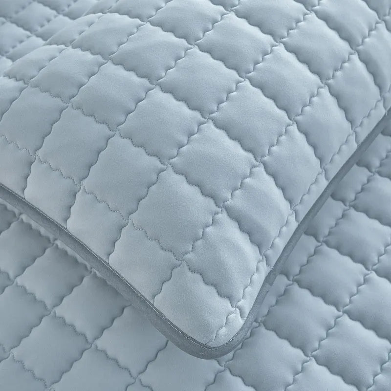 Blue waterproof fitted sheet with elastic corner stretched over a mattress.