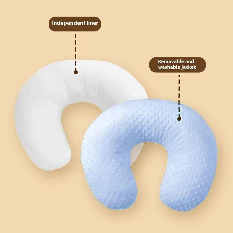 Multifunctional nursing pillow with a raised spill-prevention ridge in a light blue colour.