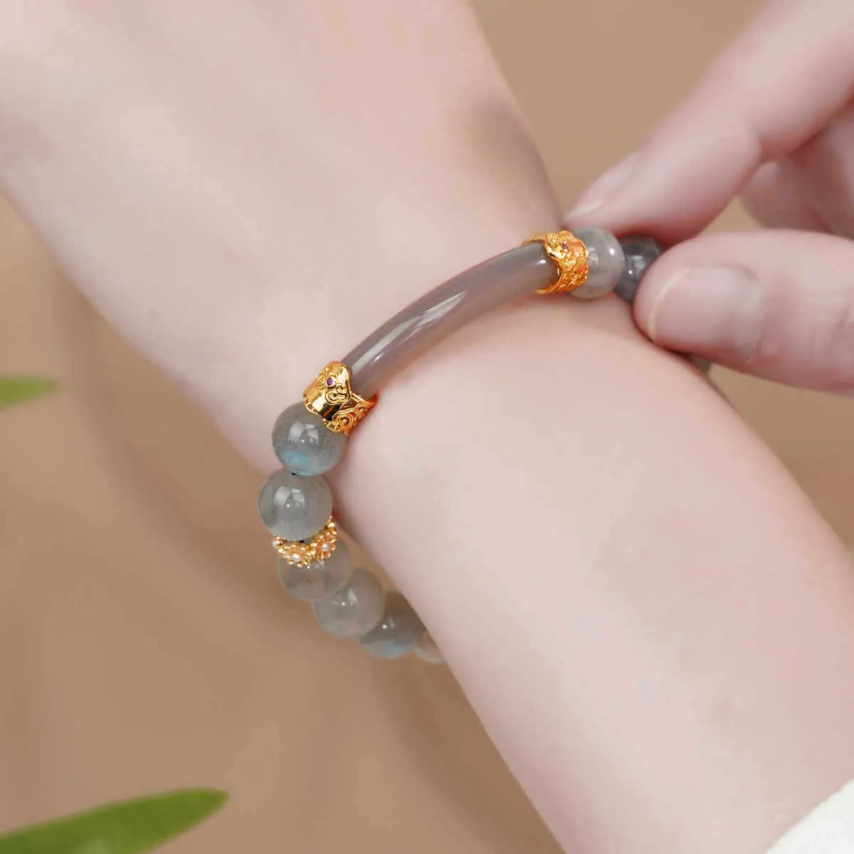 Handcrafted gray moonstone half bracelet for women with 8mm round agate beads on a wrist.
