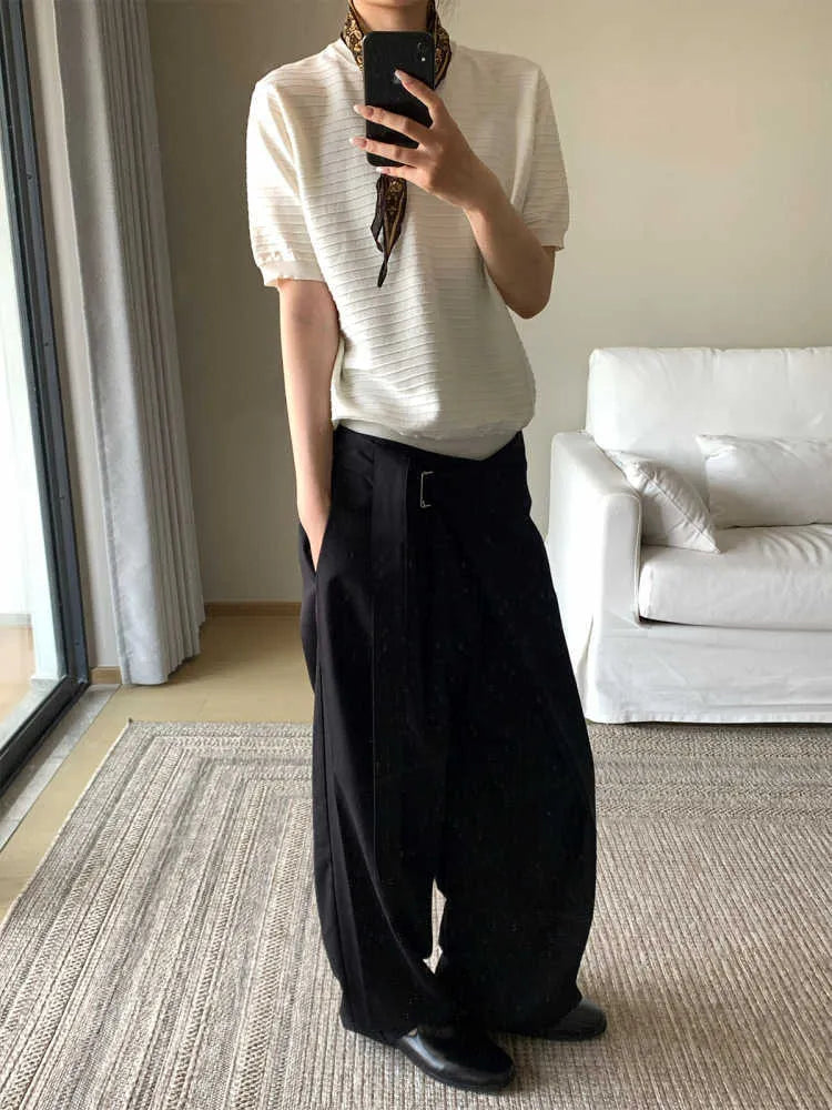 Black straight-leg trousers with a single pleat and adjustable waistband on a hanger.