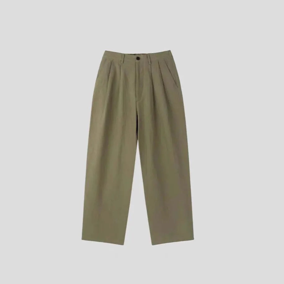 Men's loose-fit apricot cotton linen trousers with a mid-waist and pencil leg opening.