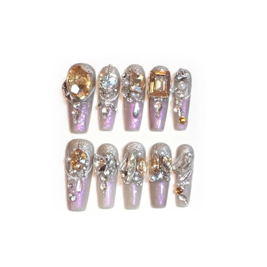 S number size luxury rhinestone false nail patches with jelly adhesive and tool options on card packaging.