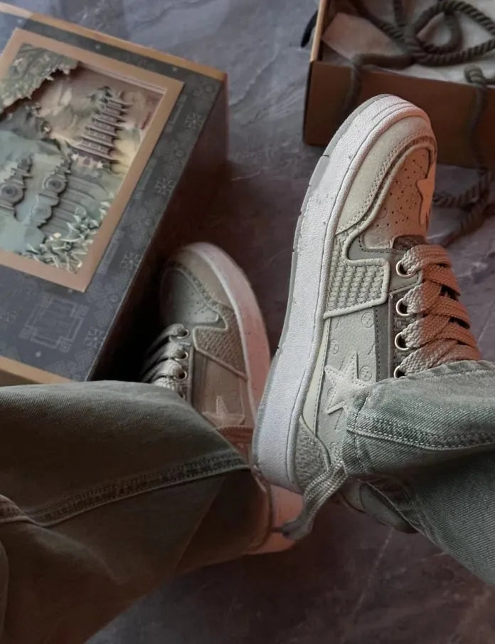 Green star-pattern low-top casual shoes with laces and a thick rubber sole.