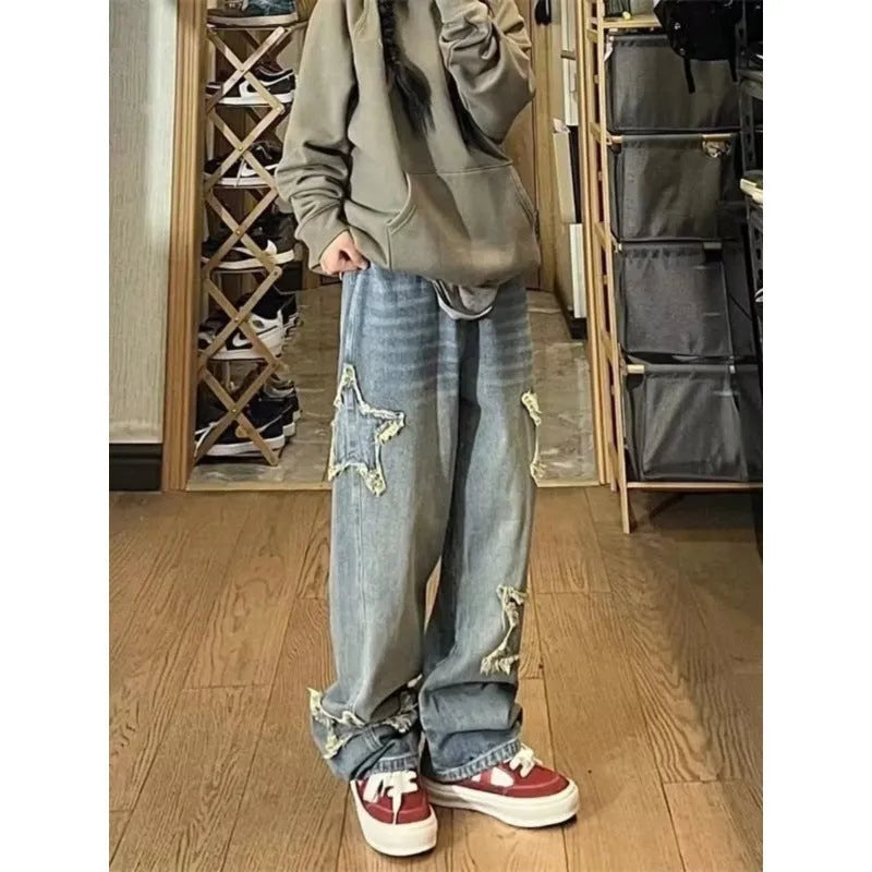Blue high-waisted women's wide-leg denim trousers on a plain background