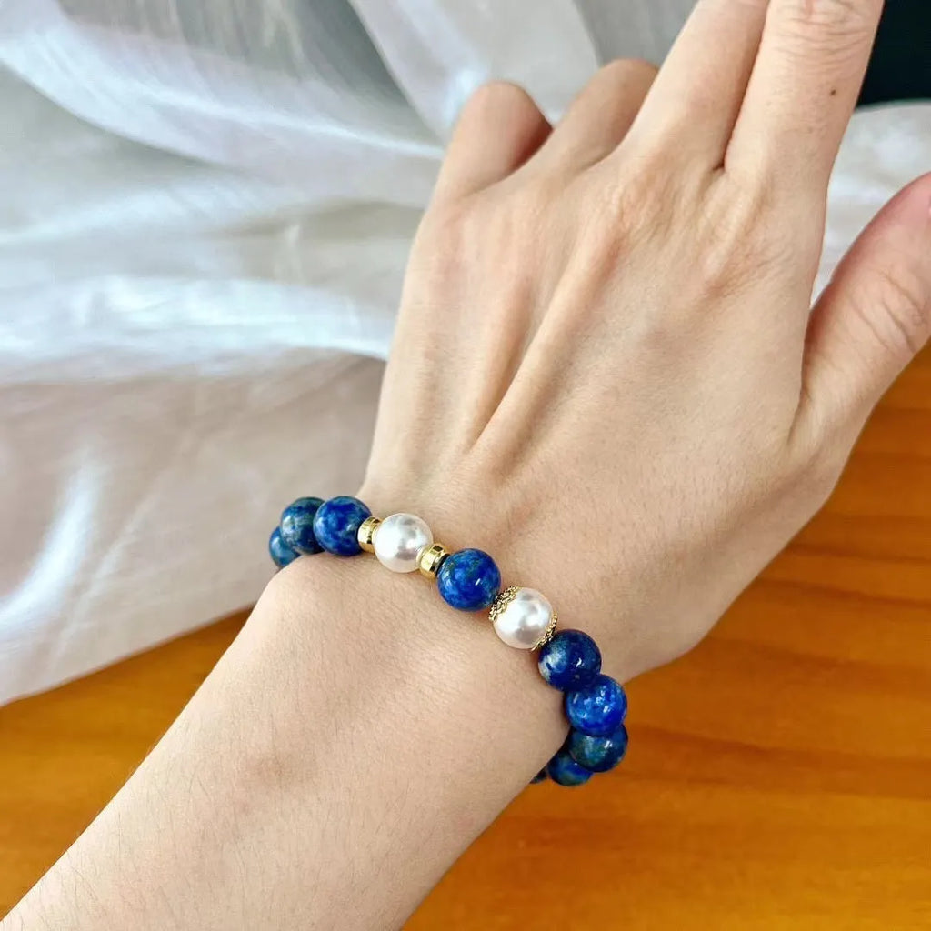 Chinese-style artistic retro lapis lazuli bracelet with green and gold stone on a white background.