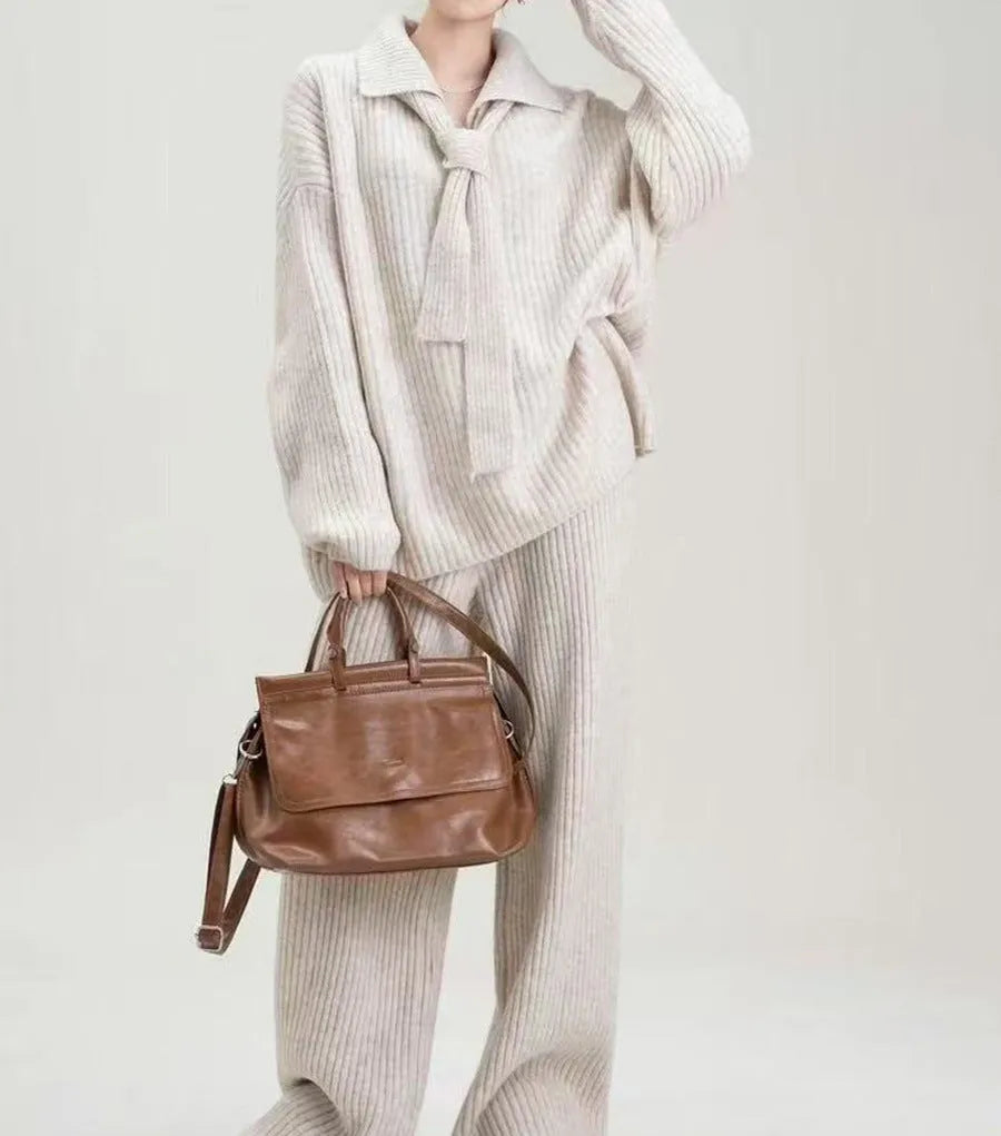 A dark grey sweater suit two-piece set featuring a long-sleeved knit top and matching casual trousers.