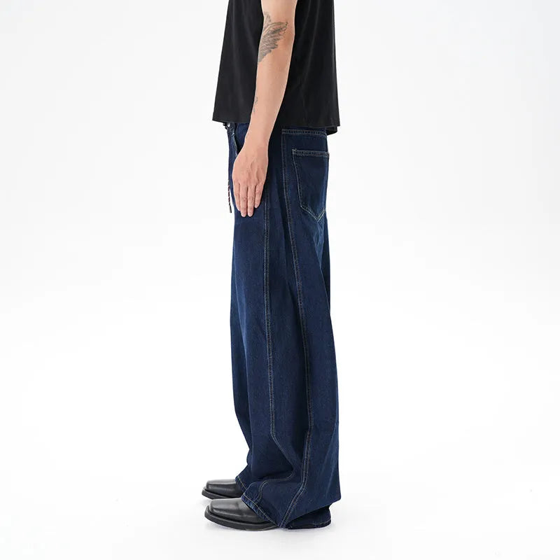 Dark blue wide-leg jeans with a distressed wash on a denim fabric, showing a relaxed fit.