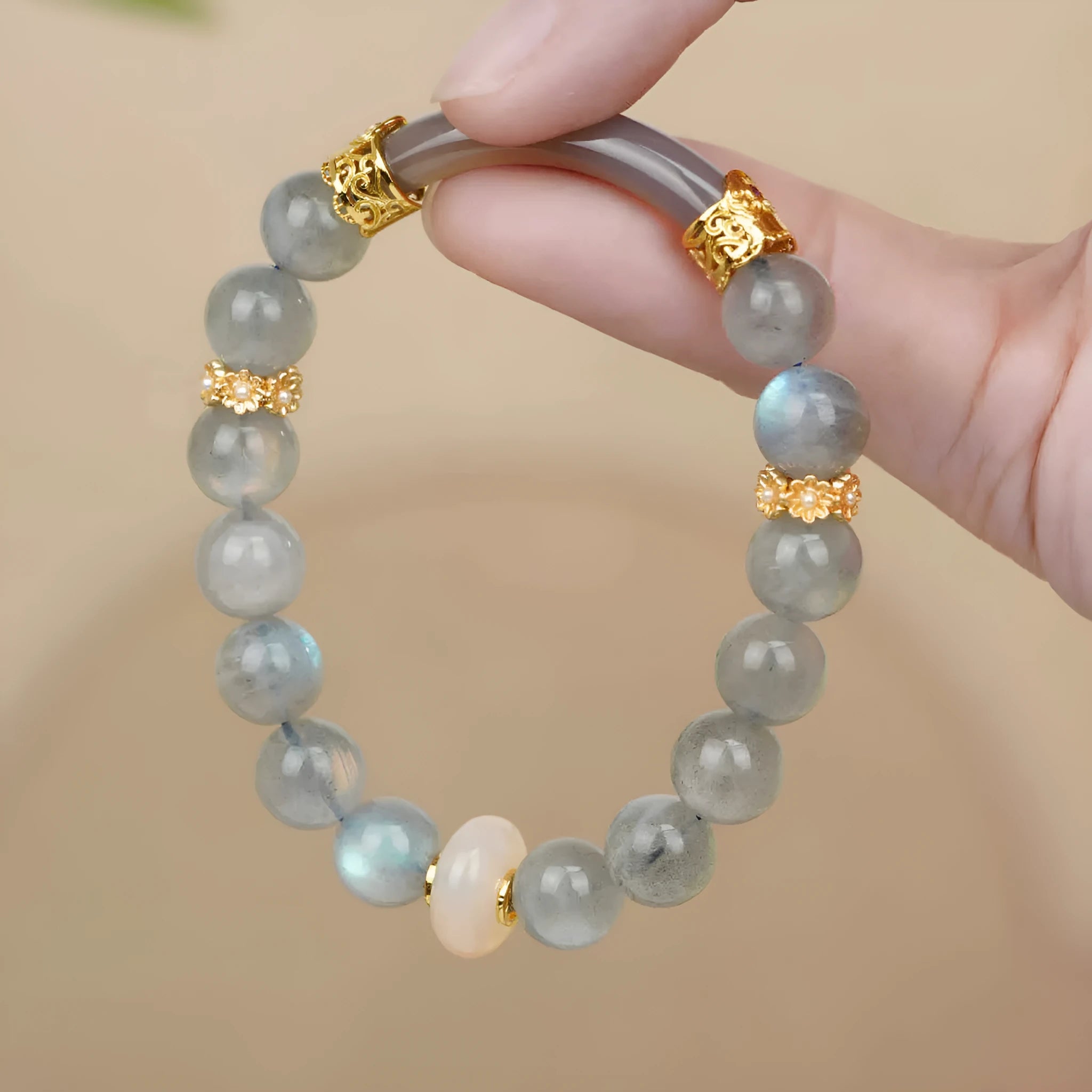 Handcrafted gray moonstone half bracelet for women with 8mm round agate beads on a wrist.