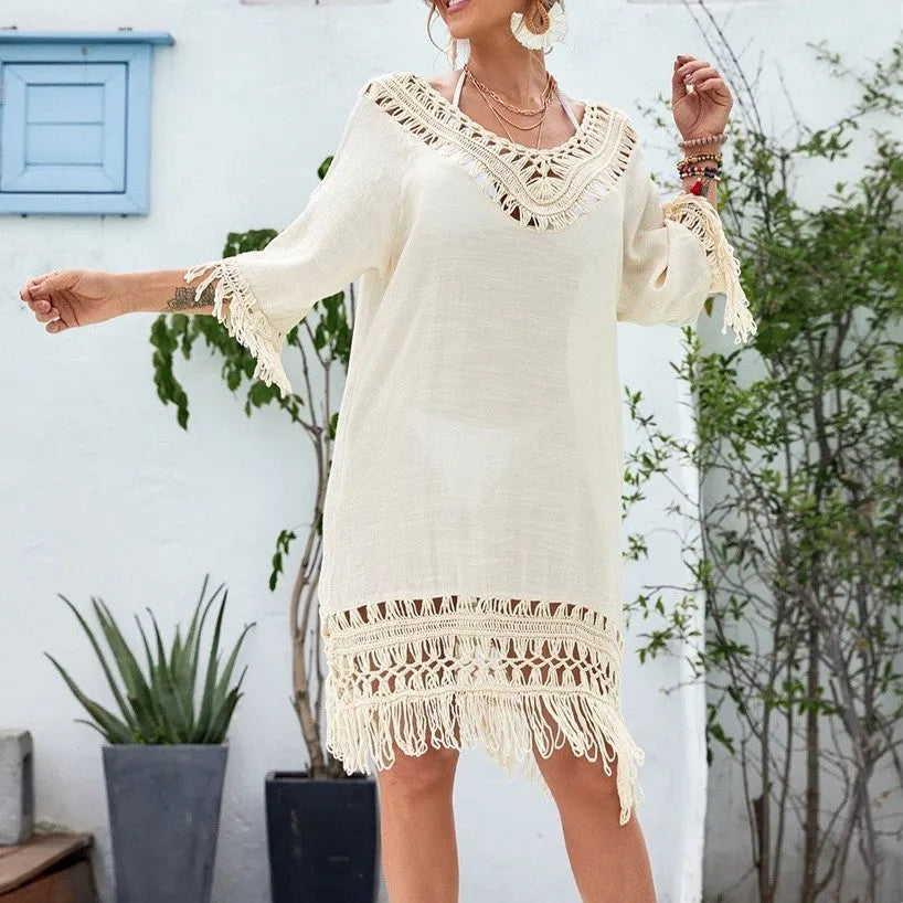 Apricot women's crocheted patchwork beach dress with half sleeves on a hanger.