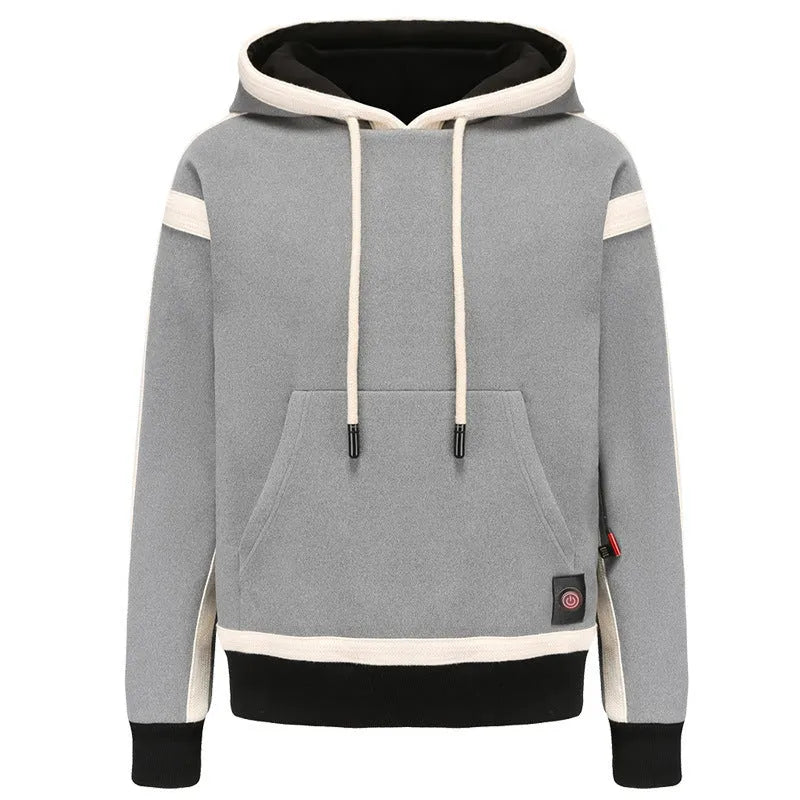 Women's USB heated jacket hoody in black, with brushed fabric and knitted construction, shown outdoors in cold weather