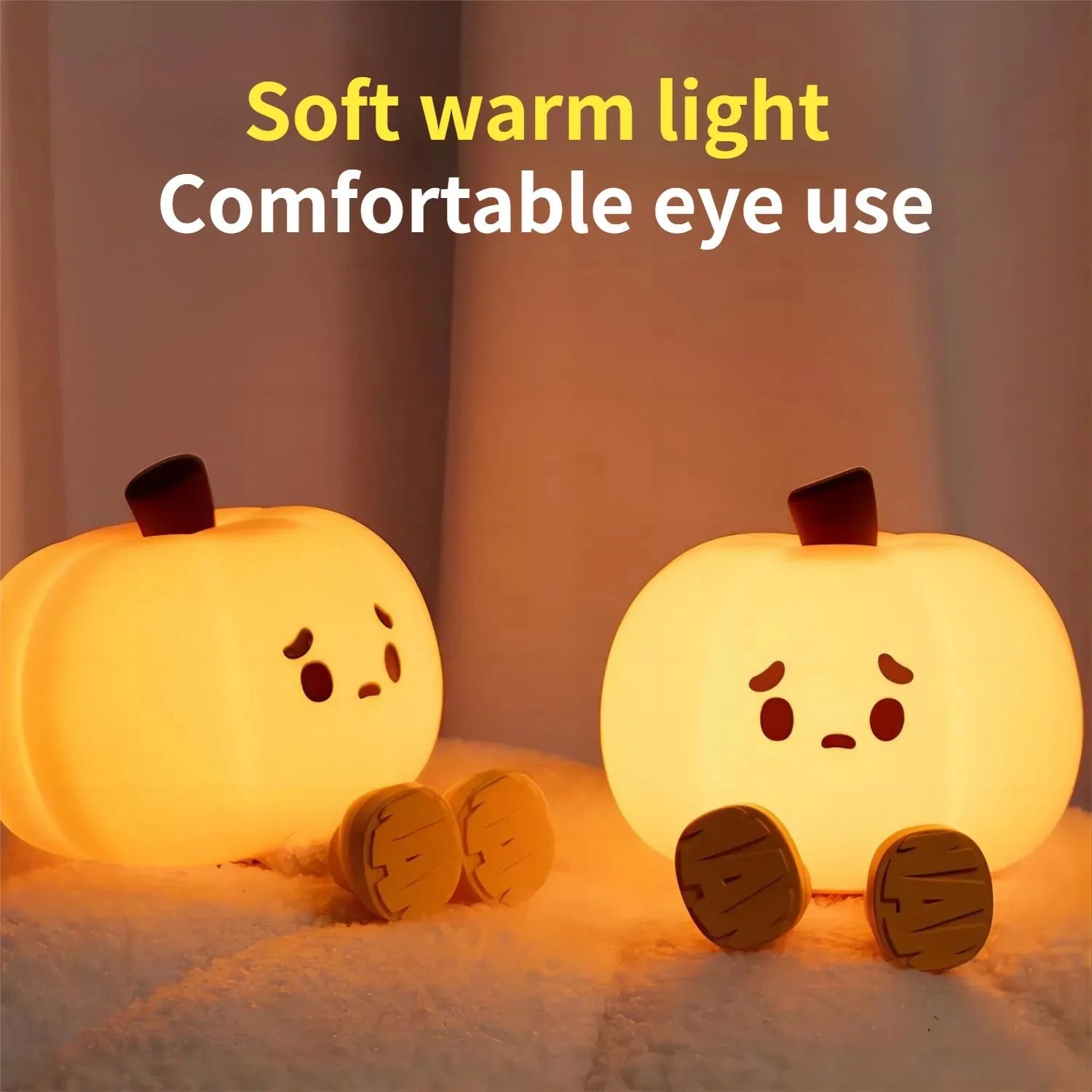 Soft orange silicone pumpkin-shaped night light with a warm glowing face on a table.