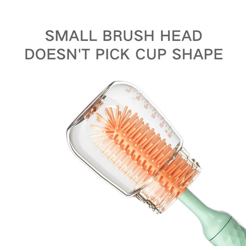 Pink and green electric baby bottle brush with rotating silicone head and USB charging cable