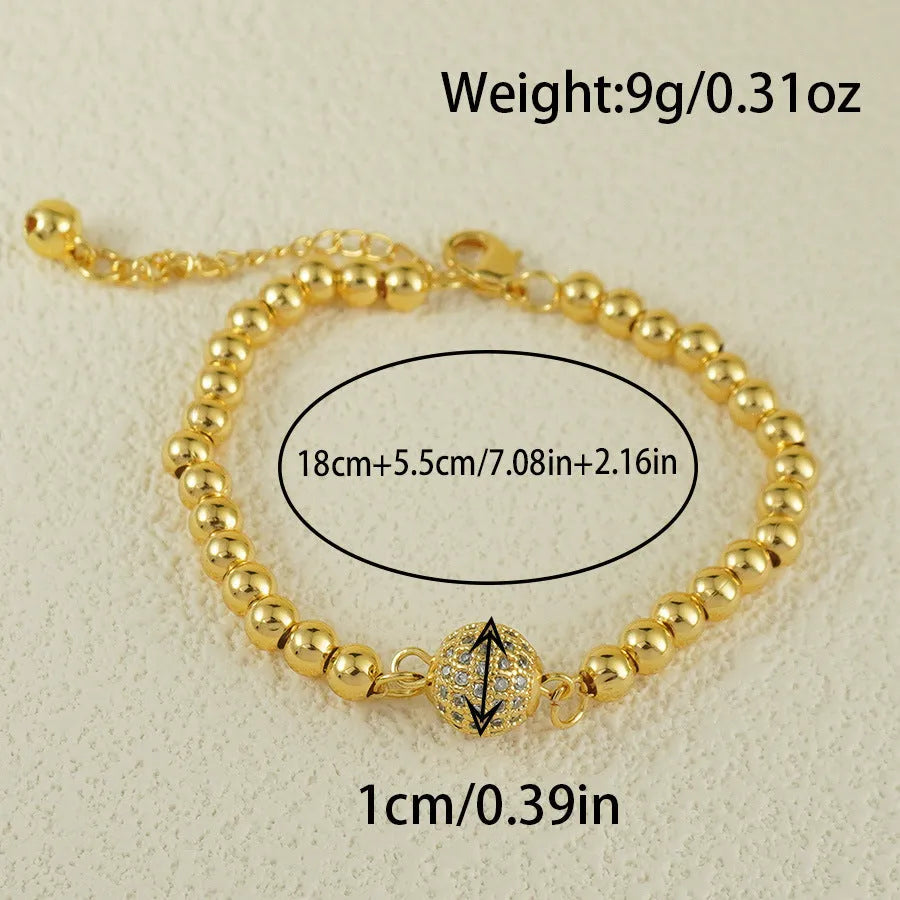 Close-up of a women's copper bracelet with a heart shape and a single round zircon stone in an Arabic-style design.
